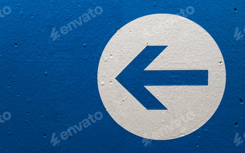 Preview: Closeup of an arrow sign on a blue wall