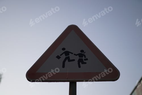 Preview: Children caution road sign on the background of the clear sky