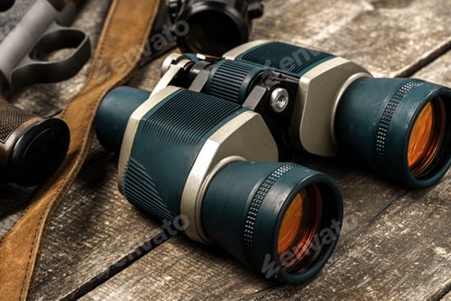 Preview: Hunting equipment binoculars on wooden background close up