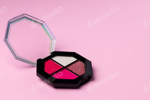 Preview: Set of eyeshadows make up products on pink