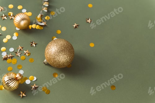 Preview: Festive green colour background with shiny confetti and golden decorating balls for Christmas tree