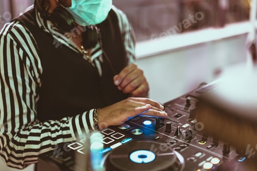 Preview: Dj mixing music wearing face mask during covid19 - Party nightlife concept