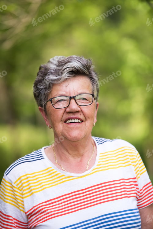 Preview: happy senior woman with eyeglasses