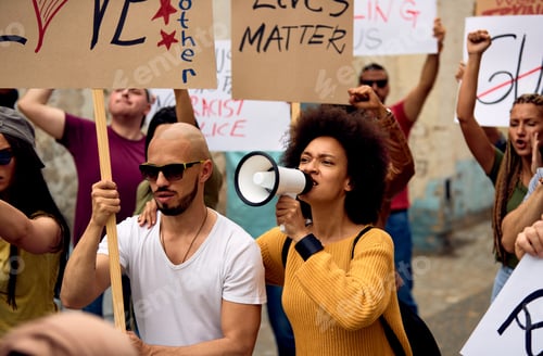 Preview: Large group of people protesting for human rights on city streets.