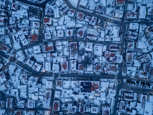 Preview: Snow-covered rooftops create a stunning winter landscape in a quaint Bansko town at twilight