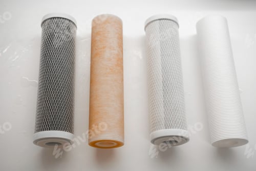 Preview: Dirty and clean filters in the reverse osmosis system on the table