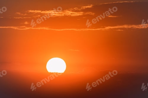 Preview: Dramatic sunset sky with dark clouds and red sun