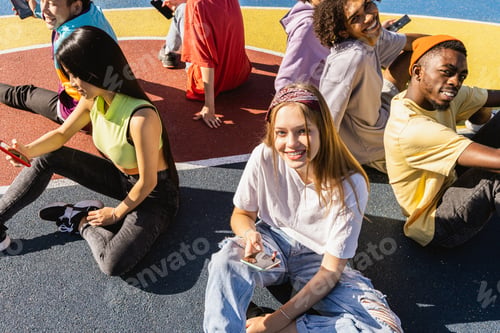 Preview: Multiracial group of young friends bonding outdoors