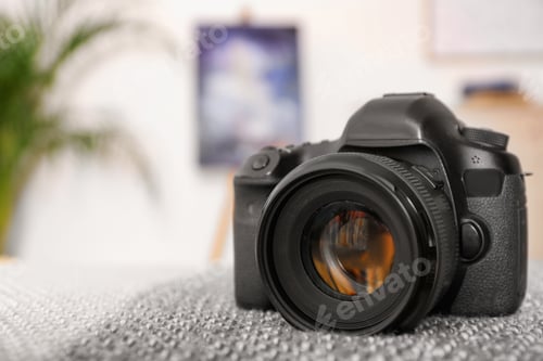 Preview: Professional digital camera against blurred background. Space for text