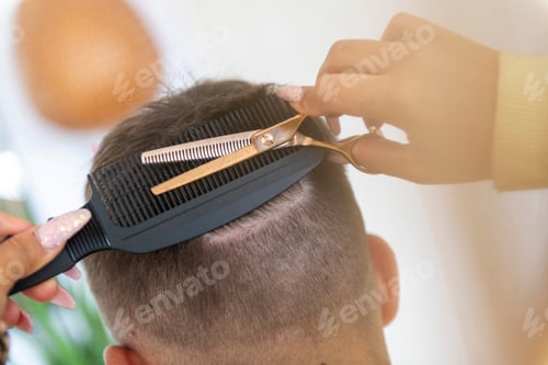 Preview: Expert hands giving a fresh haircut.