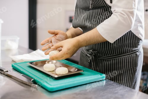 Preview: The chef prepares cheese pancakes in the kitchen of the cafe.