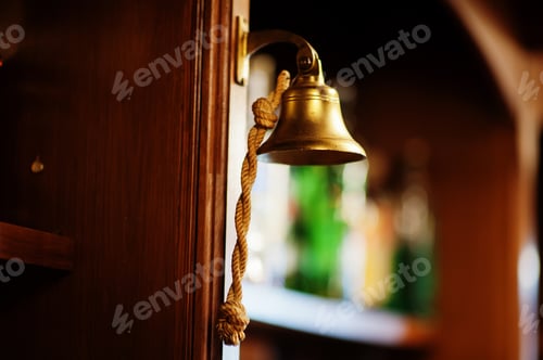 Preview: Old bell with woven rope in bar counter.