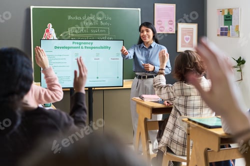 Preview: Young Adult Hispanic Woman Teaching Diverse Teenagers in Classroom Setting