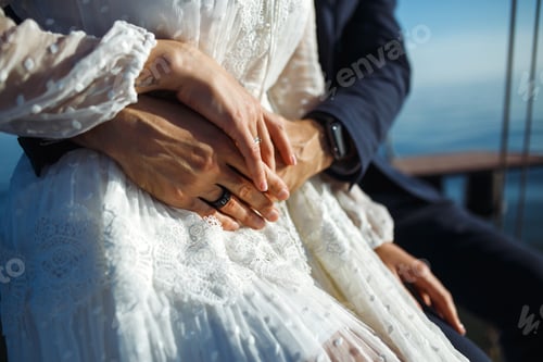 Preview: Bride and groom's hands with elegant wedding rings. Wedding details. Together. Wedding day.