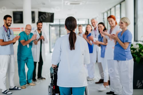 Preview: Medical staff clapping to senior patient who recovered from serious illness.