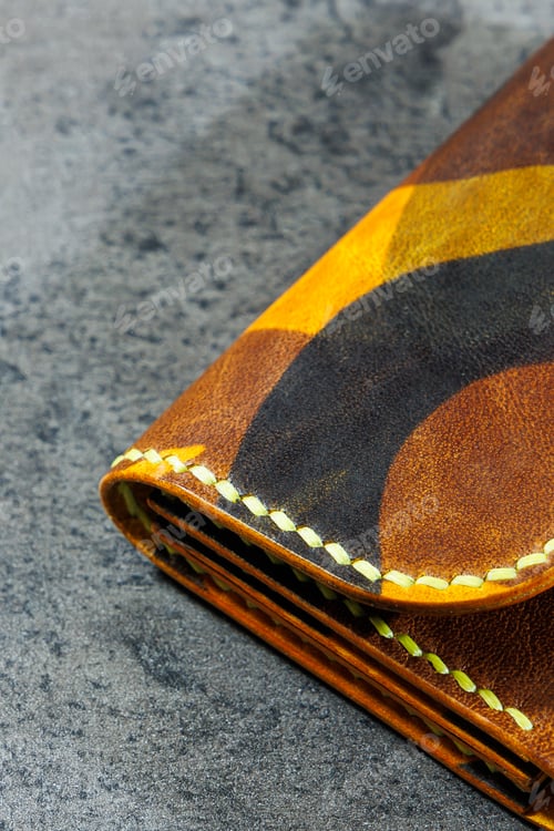 Preview: Handmade genuine leather products. Men's and women's wallet. Lying on a gray background