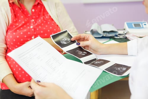 Preview: Young pregnant woman at doctors office