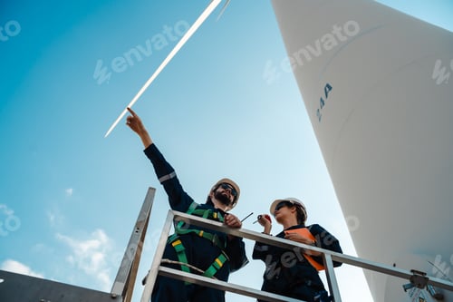 Preview: Technician and Engineer Working on a Windmill Turbine in the Field, Harnessing Renewable Energy