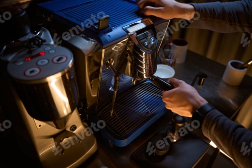 Preview: Barista with portafilter preparing aromatic drink in coffee machine