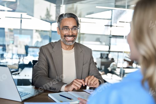 Preview: Smiling Man in Meeting at Corporate Office