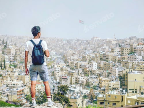 Preview: A young traveler / backpacker enjoying the cityscape of Amman, Jordan.