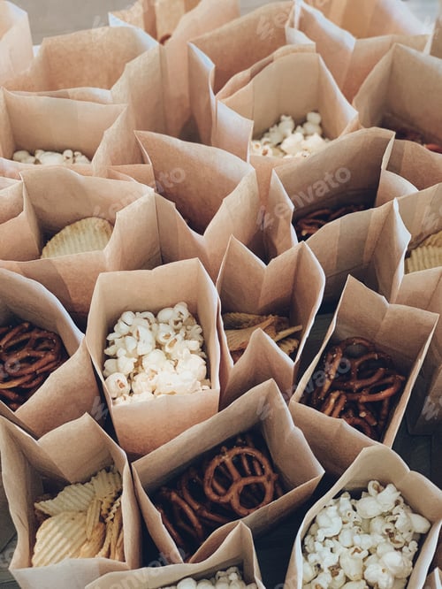 Preview: Popcorn, pretzels and chips are divided into small brown bags for a birthday celebration