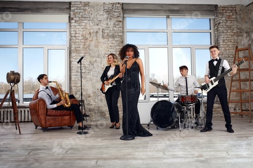 Preview: Repetition of multi ethnic jazz band in loft. Bass guitar player, electric guitar player