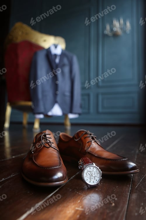 Preview: still life, brown men's shoes and men's watch against the background of a jacket on a chair