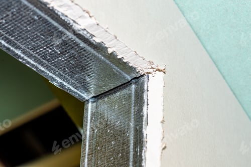 Preview: Mounted green plasterboards to an aluminum loft frame, visible black screws.