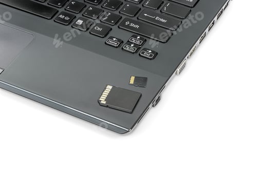 Preview: Memory card and adapter laying on laptop