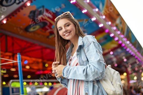 Preview: Outdoor photo of positive young pretty woman with long brown hair looking to camera