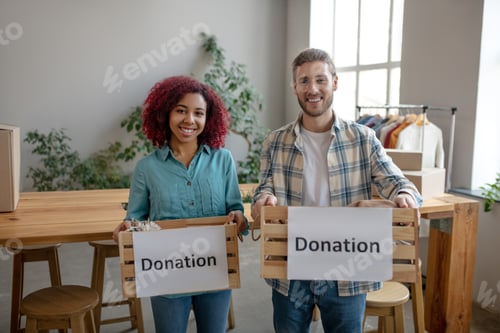 Preview: Young girl and man standing with wooden boxes in hands.