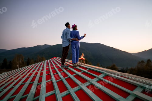 Preview: Man and woman enjoy beautiful sunset in the mountains