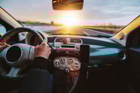 Preview: Rear view of man driving car on the highway