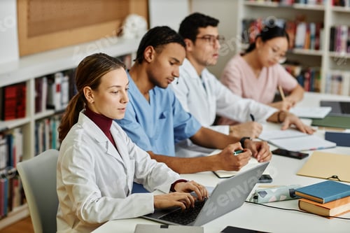 Preview: Diverse group of young med students sitting in row during lecture or seminar