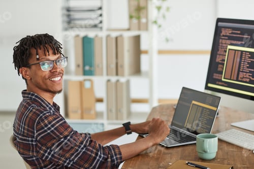 Preview: Smiling African-American Man Writing Programming Code