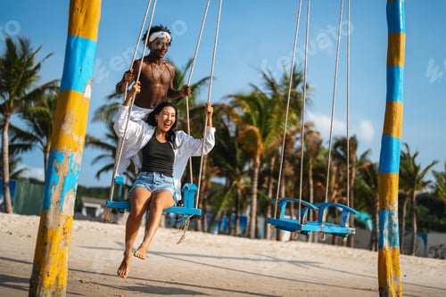Preview: Interracial couple enjoying a romantic beach getaway, embracing love, laughter, and togetherness