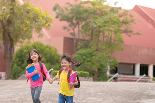 Preview: Back to school. Two cute asian child girls with school bag holding book and walk together