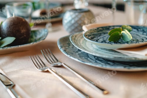 Preview: Beautiful elegant table setting with green stylish dishware and silver cutlery