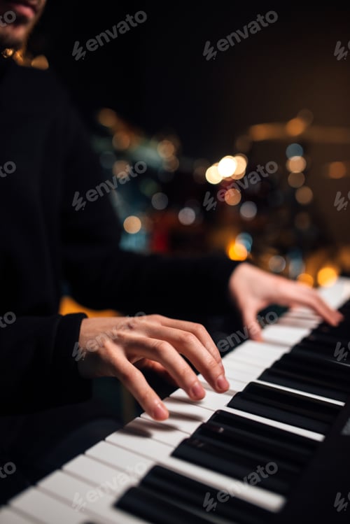 Preview: Man playing the synthesizer keyboard close up.