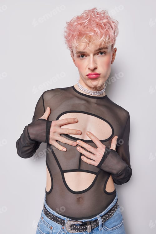 Preview: Indoor vertical shot of young fit European guy with non traditional orientation standing in centre
