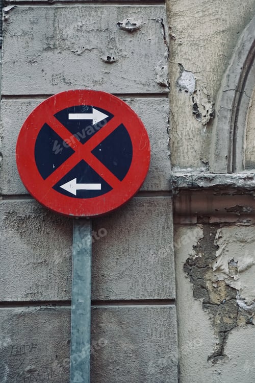 Preview: Direction sign against an old stone wall