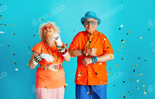 Preview: Beautiful senior old couple wearing fancy party clothes acting in studio on a colored background.