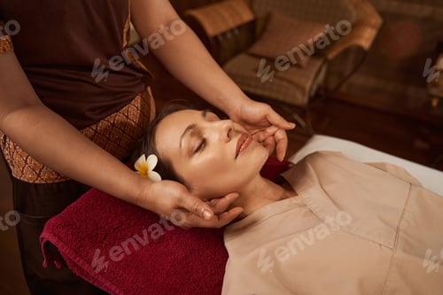 Preview: Female massotherapist giving her client acupressure massage
