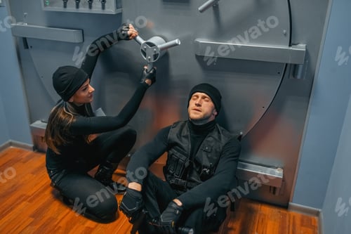 Preview: Male and female robbers trying to break vault lock