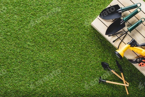 Preview: top view of gardening tools and equipment on grass
