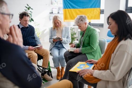 Preview: Group of seniors praying for Ukraine together in church community center