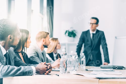 Preview: multiethnic businesspeople having conversation in conference hall