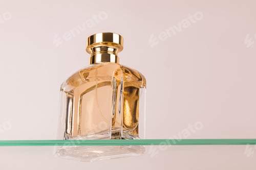 Preview: Beautiful glass bottle of cosmetic spray, perfume, eau de toilette on a floating glass surface.