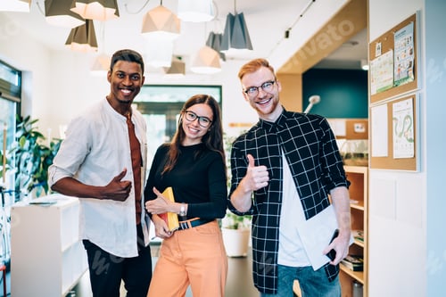 Preview: toothy multicultural students showing OK while posing